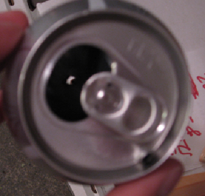 You can see the entry hole through the opening in the can, and the exit on top.