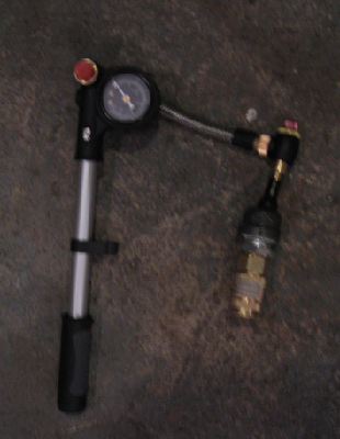 This is my trusty (400 psi capable) shock pump with female quick connect attached. The schrader in the endcap starts to really bulge out around 200 psi, so I am reluctant to take it any higher untill I do something about it.