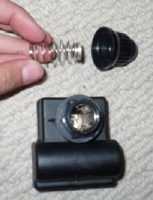 First, take apart the Igniter by unscrewing the button/cap and pulling the spring from the button.  It pops right back in so don't worry about pulling it out.