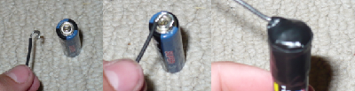 Bend the end of the other wire into a &amp;quot;U&amp;quot;-shape so it fits around the small part on the positive end, then secure it with electrical tape.  Again, don't use too much tape....
