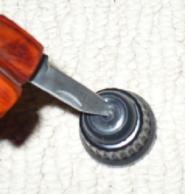 Now use a knife or sharp tool to make a hole in the top/middle of the rubber button.  No more than a few cm wide should be perfect.