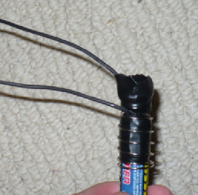 Work the battery inside the spring as far as you can towards the top until it is snug.