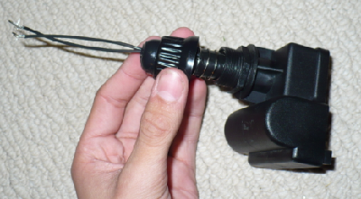 Now string the wires through the hole in the rubber button and screw the assembly back together.  It may be a tight fit but the tighter, the better because that's less of a chance of any of your connections coming loose.  You can zip tie the wires together to keep them from moving if desired.