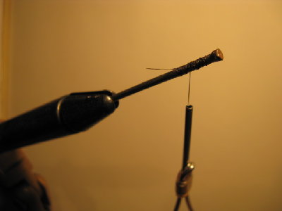 2- The first thing you will need to do is put the point of the nail in the vice, and put a few wraps of thread on the back