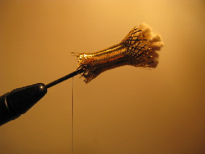 4- Cut a small section of the flash minnow body material and carefully slide it over the back of the nail like this-