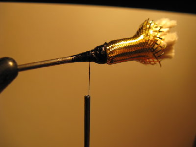 5- Take your thread and wrap the front of the flash minnow body material so that it is secure. Then, with your thread, put several half-hitches around the wraps and then coat them with clear nail polish, super glue, etc.