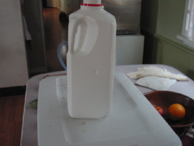 Milkjug was filled with water you can just see the hole and on the other side you can feel a dent.
