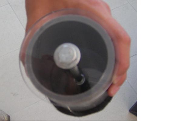 The piston from the rear. I forgot to add another rubber disk to the back. The beige thing is my hand. You can't see the nuts from this angle.