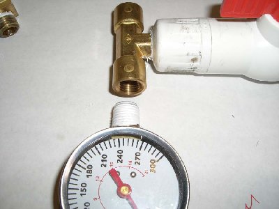 Step 11<br />Wrap the threads of the gauge with teflon and thread into the tee