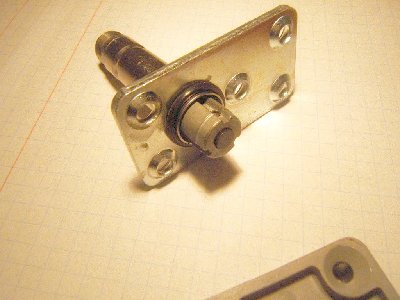 that small cylindrical thing with springs is acctually what is being pulled by the solenoid... it has rubber on the side facing the valve.... when it is lifted upwards air can pass through that small brass disk with an orfice