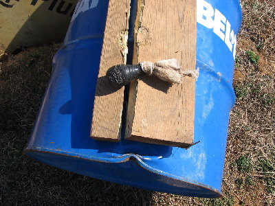 3oz. lead shot bean bag load, an old sock, 3oz of shot, tie a not and wrap in tape, check out the pice of 2x10, it also punched holes through the plywood, I just had to keep repairing the tape, when fired at 30 degree angle it landed past the crest of the above mentioned hill...