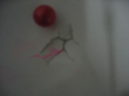 My best grouping compared to a paintball( 3 paintballs went trough this hole )