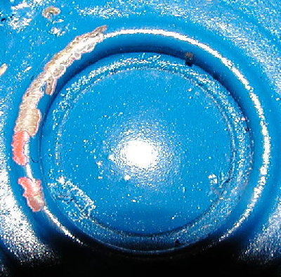 Disposable Freon tank rupture disk.  On the inside of the tank is a second layer with about a 3/32 inch orifice to limit the burst energy.  This is not designed to eject the disk, but retain it like a pop can pop top.