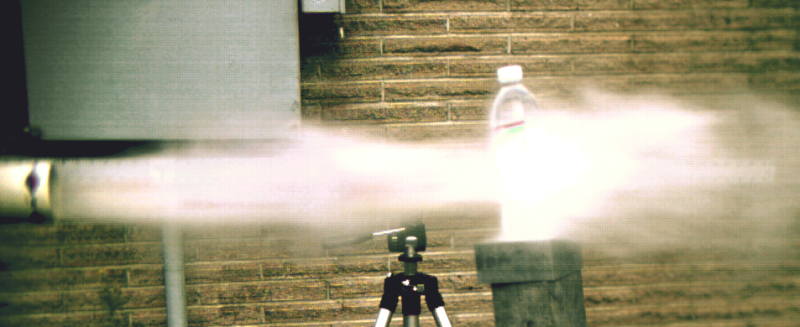 The apple is about 6 inches away from the water bottle.