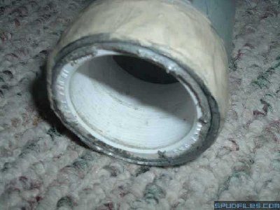 This shows the chamber with the first piece of pipe sleeved in. It is a 1.25&amp;quot; repair coupling wrapped with a few layers of duct tape to fit snugly. The gunky stuff around the chamber threads is plumbers putty.