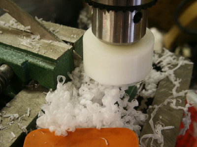 HDPE piston turned on a drill press