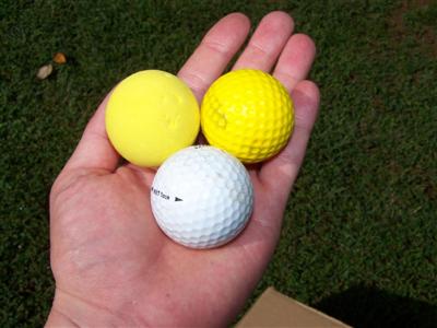 Three balls in the hand, soon in the box!<br />The dimpled ball is the squishier of the two.