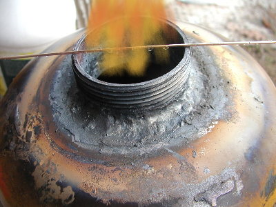 The thin dark flame danced at the contact with air like this.  Edited photo, not the real flame.