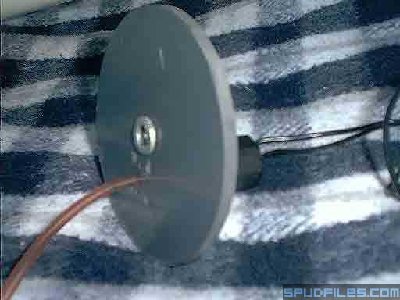 Picture of the back plate as seen from the inside. The washer glued in the middle is to hold the spring in place. That's the pink vent tube going into the solenoid housing with two hole (above and below the vent tube) to equalize the solenoid housing.