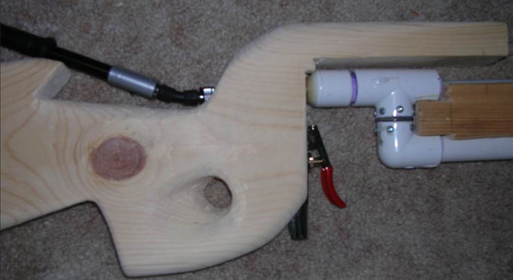 This is a picture I took before I completed the finishing touches, it just displays how the shock pump connects through the stock to a schrader valve  mounted to the back of the valve