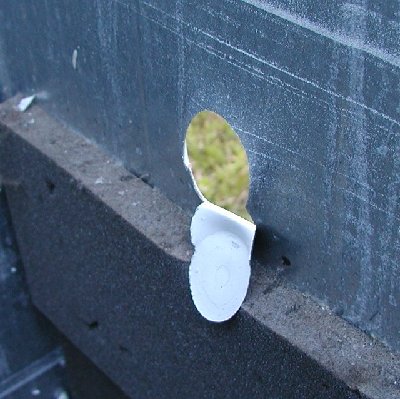 D Cell fired from a golfball barrel made this hole.  I would have loved to have gotten a high speed video of the making of this hole.