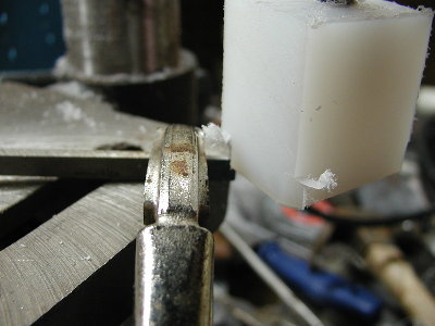 A suitable cutting tool is clamped to the drill press table.  I used a wood chisel.  The rotating block is lowered past the cutting tool taking off a small amount in each pass.