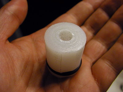 Piston face has a place to screw on a rubber washer.