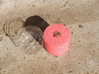 The sabot is in 2 parts, a seal for the barrel and a foam insert to orient the battery.  The hole in the foam goes all the way through so only the plastic bottle pushes the battery.