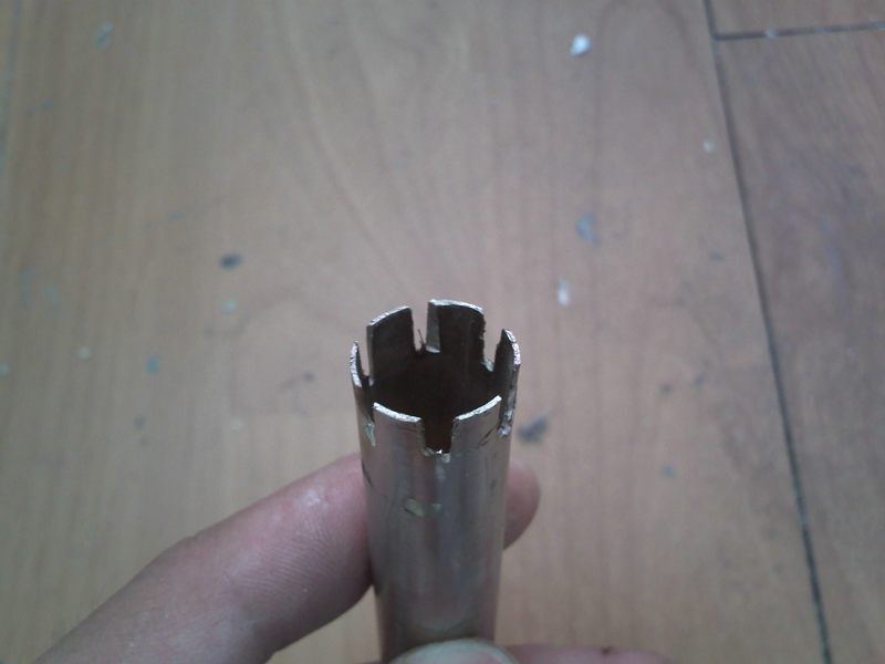 cut some 1/2 tube, lenth depende the spring you are going to use. and cut 6 grooves so it fits on the end cap of the blowgun