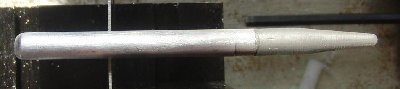 lead weight in the nose, conical delrin tail, hit sideways at 10m