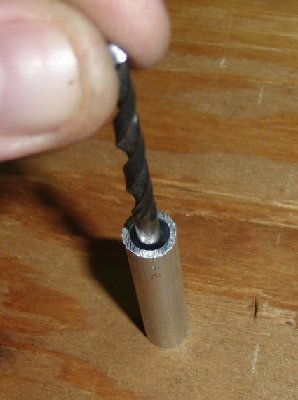 4) push the whole assembly into the secton of barrel tubing, place it on a hard surface and tap the rod firmly with a hammer.  This compacts the twisted end into a flat base, sealing it and adding strength.