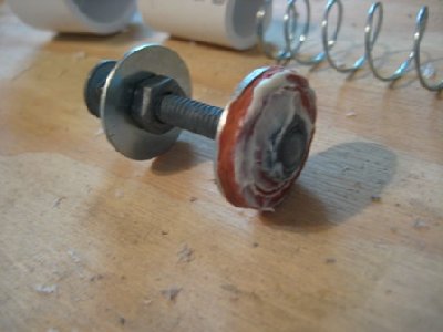 The piston. It has white grease on it.