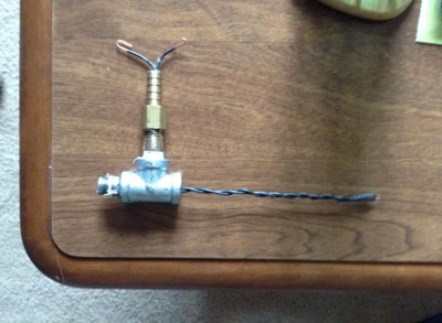 Spark plug setup, the leads are epoxied at about 1mm apart and are set to extend just about in the center of the chamber. The wires are straightened as to not allow them to make contact with the conductive body.