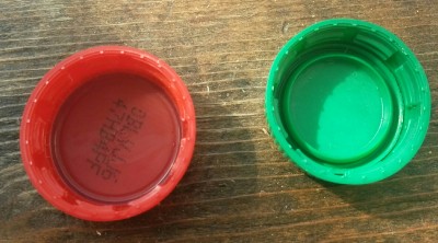 The mountain dew cap (on the right) has a beveled ring on the inside that prevents O-rings or gaskets from fitting