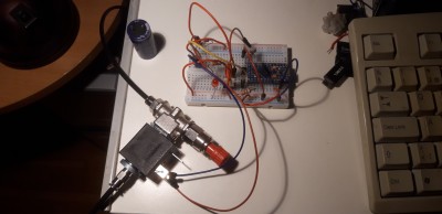 The breadboarded first prototype circuit and the three-way pneumatic valve with plugged port.