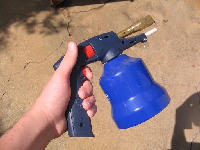Blow tourch which uses small propane tanks. (or super gas- propane and butane)