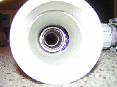 Here's a picture of the inside of the tee.  You can see the coupler that I glued on to keep it nice and square.  It also helps increase the pressure differential once the piston starts moving.  Also, you can kindof see the pipe that I sleeved inside of the tee.