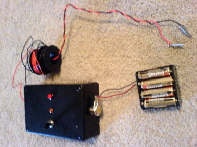 Hree's the externals.  I've got 8 AA batteries rigged to run through there.  The switch controls the LED which, when turned on, uses enough juice to prevent the system from igniting prematurely.  And of course the pretty red button makes it go boom.  i wanted a bigger red button but that's all Radio Crap had.