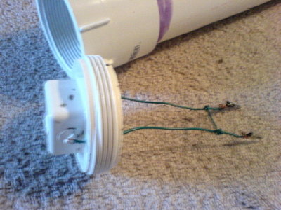 Here's the internals, basically I'm going to string a very thin wire between the gator clips which will, when current is passed through it, become quite toasty, glow orange, and pop making sparks.  If all else fails I'll use Hershey wrapper.  If you use the right width, the foils heats up enough to ignite the paper, which I'm sure will ignite fuel.  The wires run n through two holes that I drilled, then sealed with epoxy.  The wire strung between them is just to hold them steady.