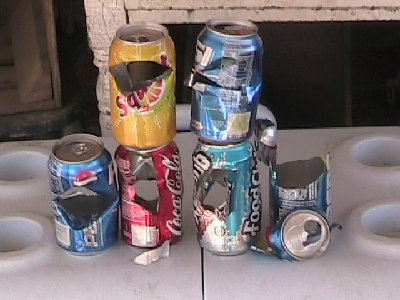 WOW this was done with one shot of my new sniper barrel and a paintball!!!!(one per can of course...15 feet away....)