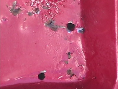 big holes in wheel barrow that is really thick metal i used a big ass peice of metal with the end cut off and it was like 4 inches long and weighed like 2 pounds....