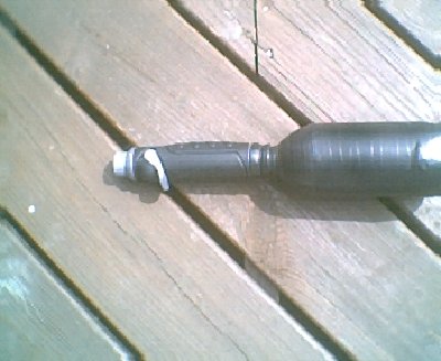 pic of the valve on the soda bottle. the  bottle is covered in black tape