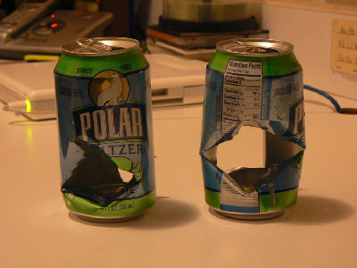 These are two cans I shot, the one on the left was with a dart, and the the one on the right was with a potato.