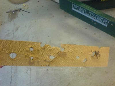 spud- wax-and epoxy-slugs shot at a sheet of thin chipboard-like material at different pressures