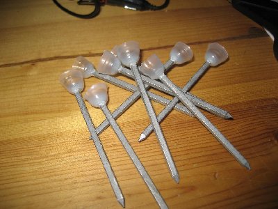 now put as little hotglue in the bottom of the cone as possible, while still covering the head of the nail.