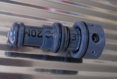 The bolt and the vent valve seat.<br /><br />The exit &amp;quot;disk&amp;quot; is on the left (an end cap with a groove for an O-ring that was on vacation when the picture was taken). The larger O-ring in the center is the opener disk seal. On the right, inside the reducer, is the vent disk, similar to the exit disk.