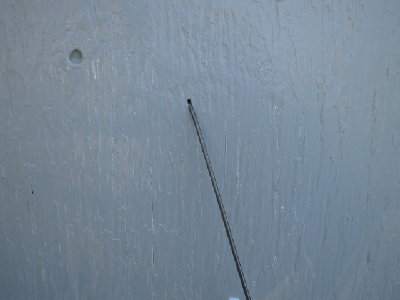 The dart stuck in the door and bent.