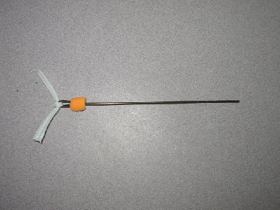 This is a dart that I made out of <br />wire coat hanger, an earplug, super glue, and the core of some cord.